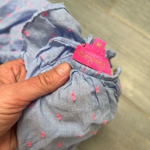 Lily top with light blue background and pink thread pattern